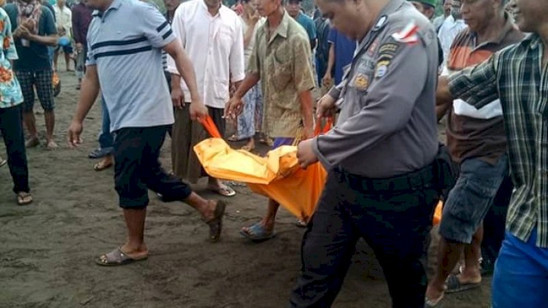 Polisi dan warga mengevakuasi mayat laki-laki yang ditemukan di Pantai Mangindara, Takalar, Jumat pagi (25/1/2019).