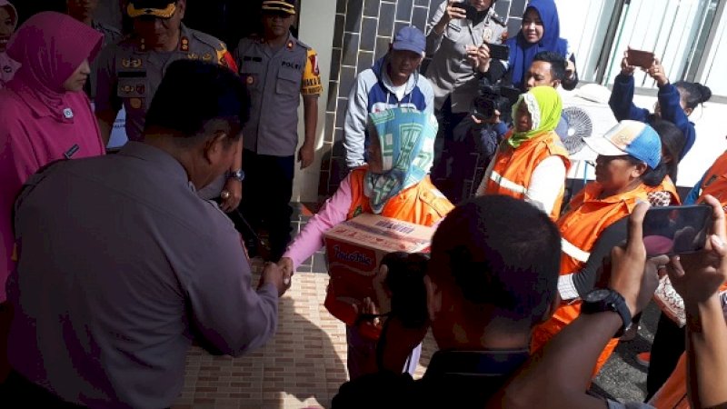 Polres Palopo menyerahkan 70 bingkisan sembako kepada petugas kebersihan dari Dinas Kebersihan Kota Palopo di Lapangan Apel Polres Palopo, Selasa (19/2/2019).