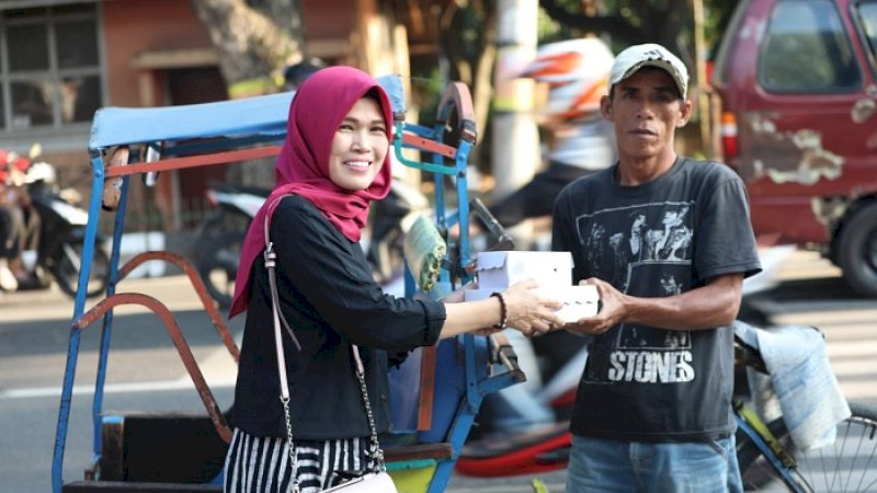 Kepala Bagian Humas dan Potokol Pemkab Bantaeng Andi Sukmawati berbagi makanan berbuka puasa di perempatan pos pelayanan lalu lintas terpadu 99, Jalan Raya Lanto, Bantaeng, Minggu sore (19/5/2019).