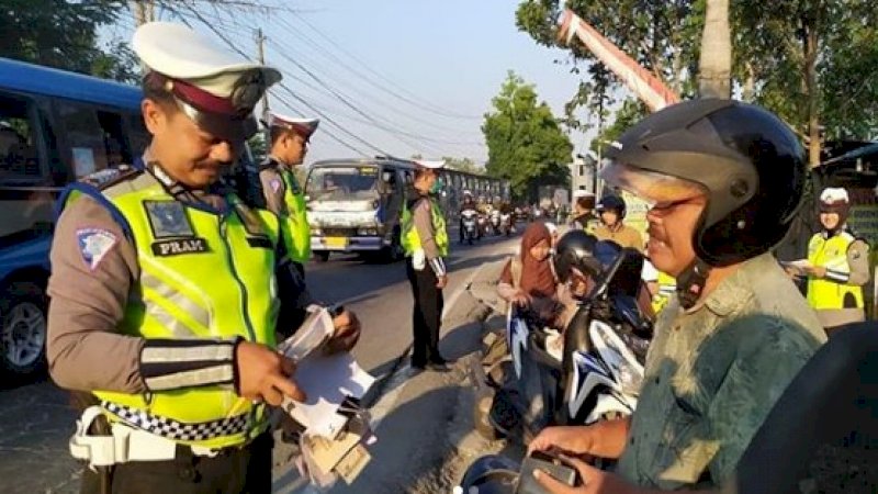 Anggota Satlantas Polres Bojonegoro, Bripka Pramono (kiri) memeriksa ayah mertua dalam Operasi Patuh 2019. (FOTO: INSTAGRAM)