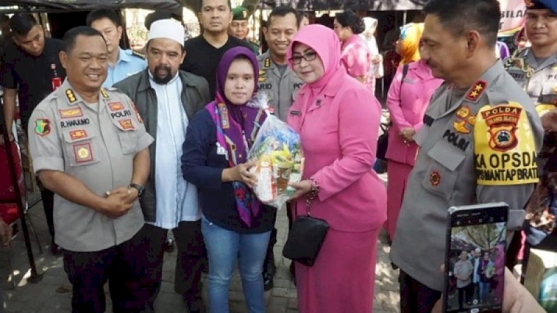 Ibu Bhayangkari Polda Sulsel, memberikan bingkisan kepada warga di pelataran Masjid Al Markaz Al Islami, Selasa (15/10/2019).