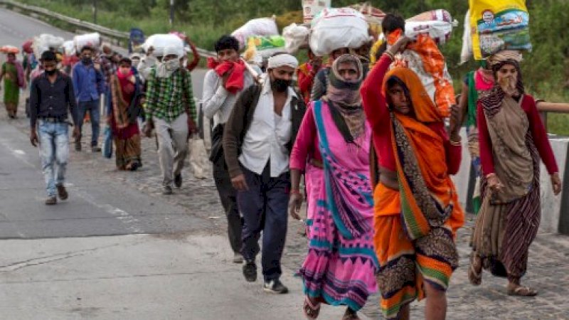 Warga India harus berjalan kaki karena transportasi dihentikan selama lockdown. (FOTO: REUTERS)