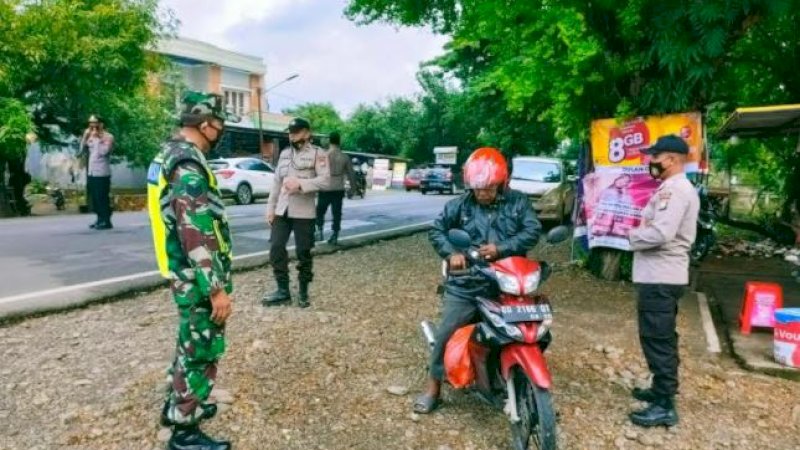 Personel dari Polsek Bontonompo, Polres Gowa, bersama anggota Koramil 1409-08 Bontonompo melaksanakan operasi yustisi penggunaan masker di jalan poros Bontonompo depan Mako Koramil Bontonompo.