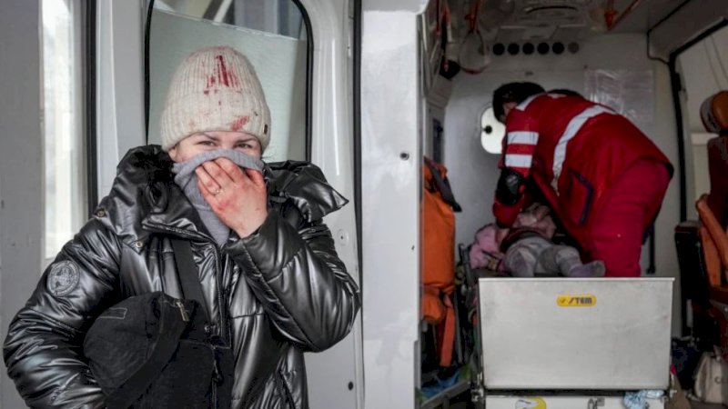 Ibu korban menangis saat tenaga menis melakukan CPR pada gadis kecil yang terluka dalam baku tembak di Mariupol, Ukraina, Ahad (27/2/2022). Gadis kecil itu akhirnya tidak bisa diselamatkan. (Foto: AP/Evgeniy Maloletka)