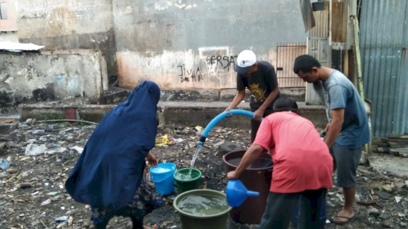 Petugas PDAM Makassar saat menyalurkan air bersih untuk koran kebakaran di Bara-baranya, Kota Makassar, (8/4/22).