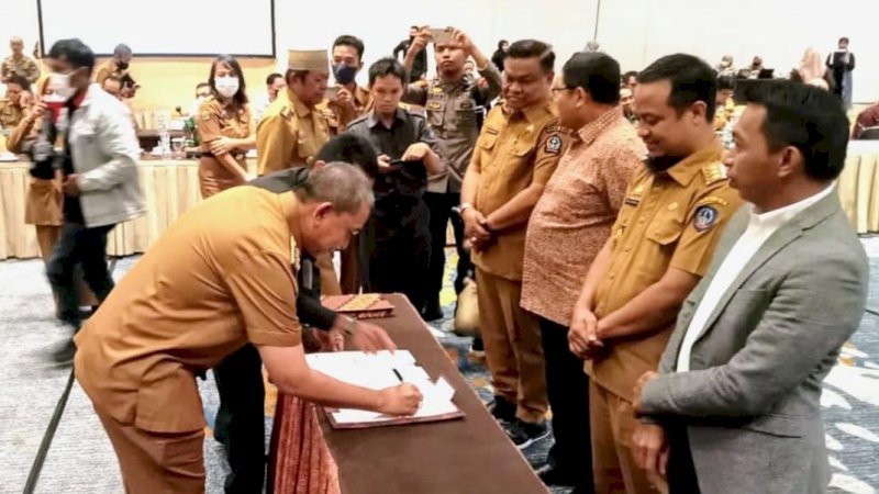 Bupati Wajo, Amran Mahmud (kiri), saat menandatangani kesepakatan bersama terkait pengendalian inflasi daerah di Sulawesi Selatan (Sulsel) di Hotel Claro, Jalan A.P. Pettarani, Kota Makassar, Selasa (11/10/2022).