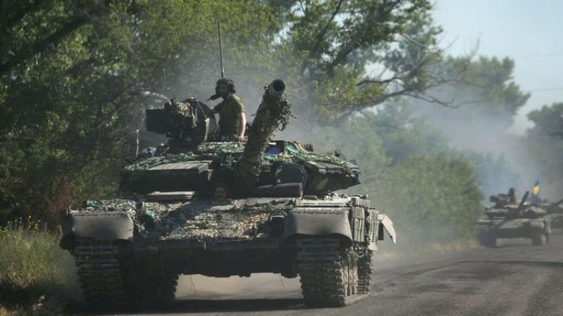 Tentara Ukraina berdiri di atas tank yang melaju di Donbass, Ukraina timur, 21 Juni 2022. (AFP/ANATOLII STEPANOV)